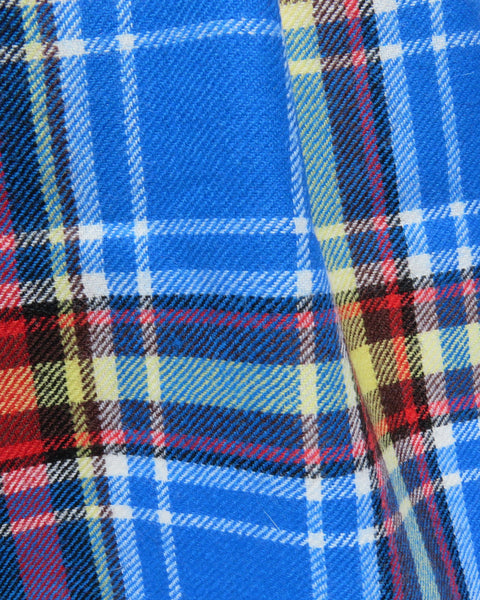 Close-up of a blue plaid scarf fabric with blue, red, and yellow colors.