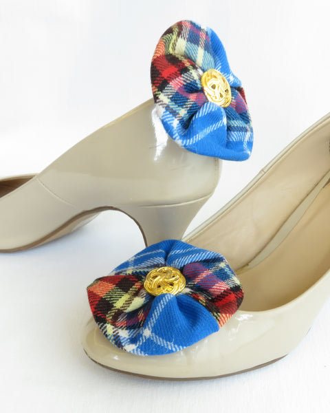 blue red white plaid oromocto tartan shoe clips on beige high-heeled shoes against a white background