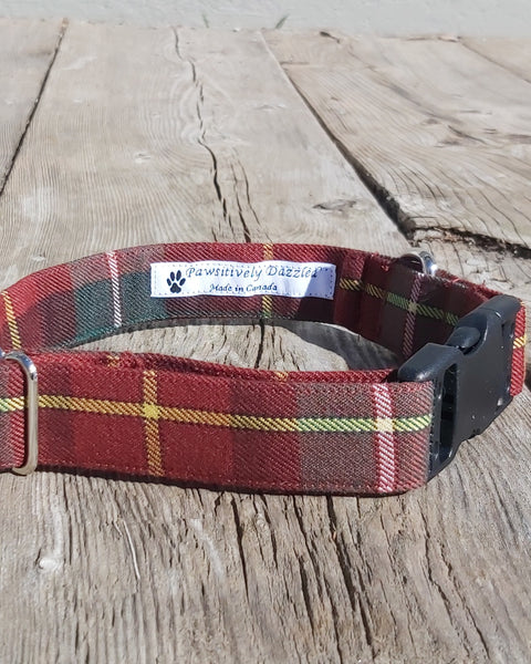 Rust, green and brown plaid dog collar with a black buckle on a wooden surface, PEI tartan - Taylors Tartans