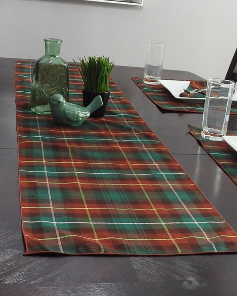 PEI tartan table runner on a dining table with decorative items.