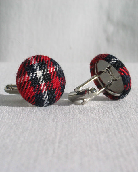 Side view of Plaid patterned cufflinks on a light gray background