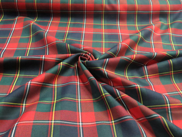 Navy, red, and green Quebec tartan fabric swirled to showcase its texture and rich plaid colors.