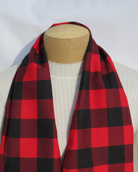 Red and black checkered scarf on a mannequin with a white background