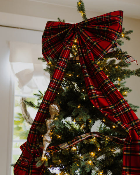 close up of a royal stewart tartan christmas tree bow on the top of the tree