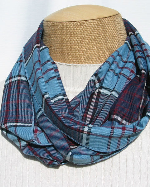 Blue, dark blue, maroon, and white Plaid scarf on a mannequin with a white background