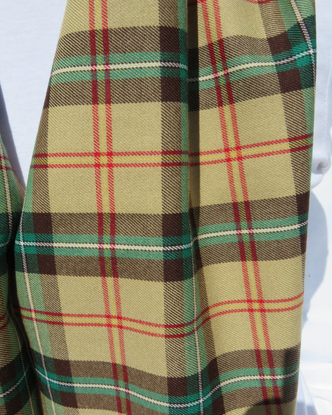 Close-up of a plaid scarf with yellow, green, brown, and red colors.
