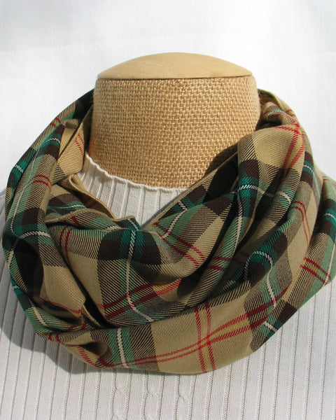 Saskatchewan Plaid tan, red, green and white scarf on a mannequin head against a white background
