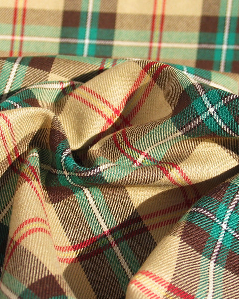 Close up of yellow, green and brown plaid material in the Saskatchewan tartan fabric