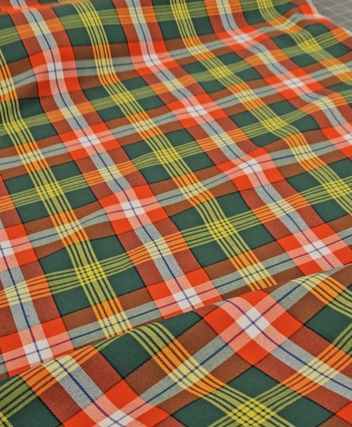 Close-up of plaid fabric with red, green, and yellow pattern
