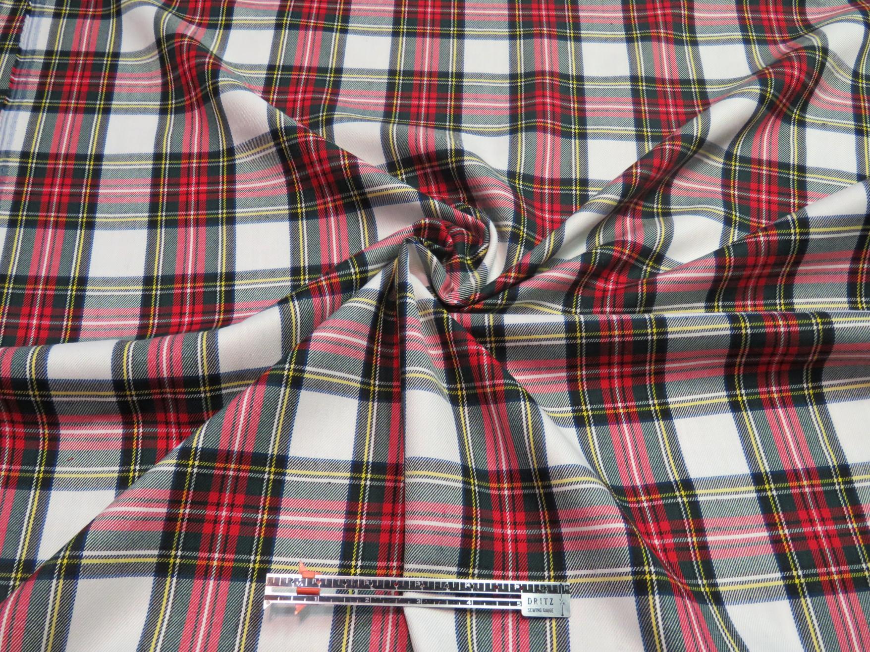 Dress Stewart tartan fabric scrunched to demonstrate its wrinkle-resistant texture and smooth finish.