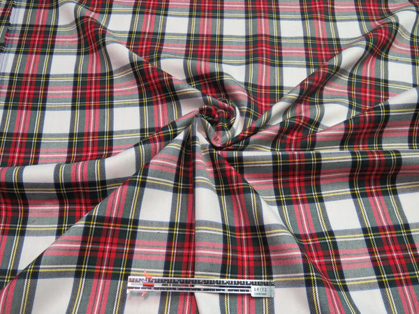 Dress Stewart tartan fabric scrunched to demonstrate its wrinkle-resistant texture and smooth finish.