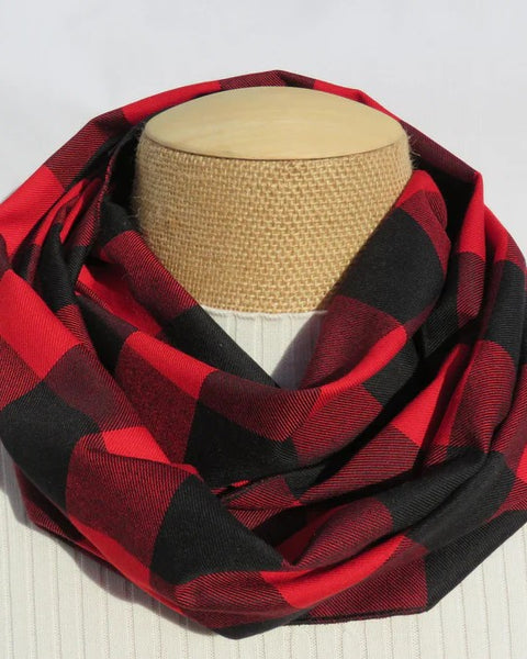 Red and black checkered scarf on a mannequin head against a white background