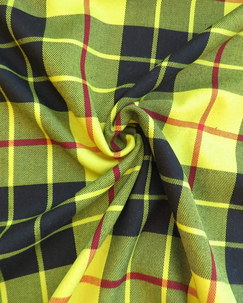 Close-up of plaid fabric with yellow, black, and red colors.