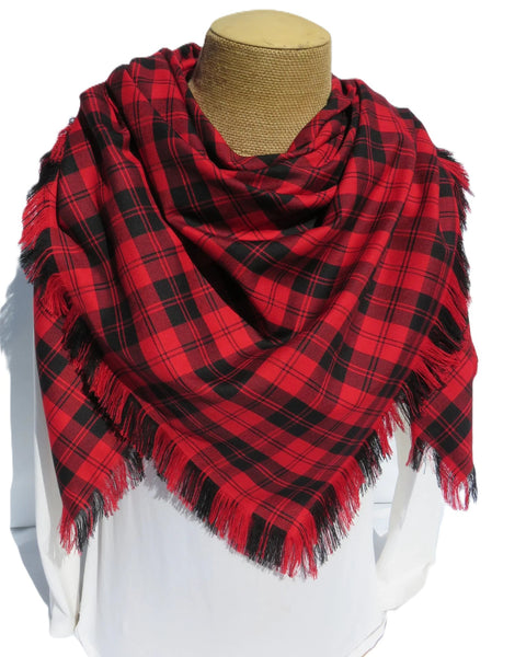 Red and black plaid scarf on a mannequin with a white background