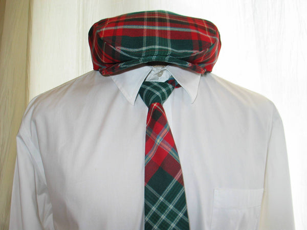 Mannequin wearing a red and green plaid New Brunswick tartan flat cap and necktie with a white dress shirt.