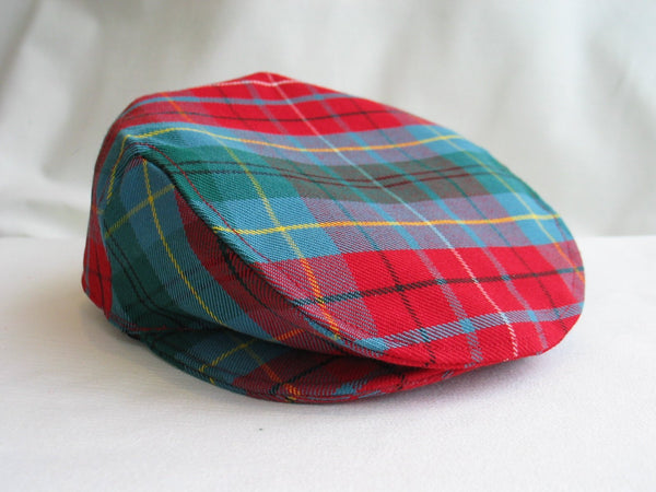 Teal and red plaid men's flat cap on a white background, handmade by Taylors Tartans.