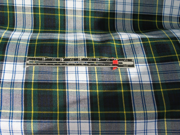 Dress Gordon tartan fabric in white, navy, green, and yellow plaid, displayed with a ruler to show the scale of the pattern.