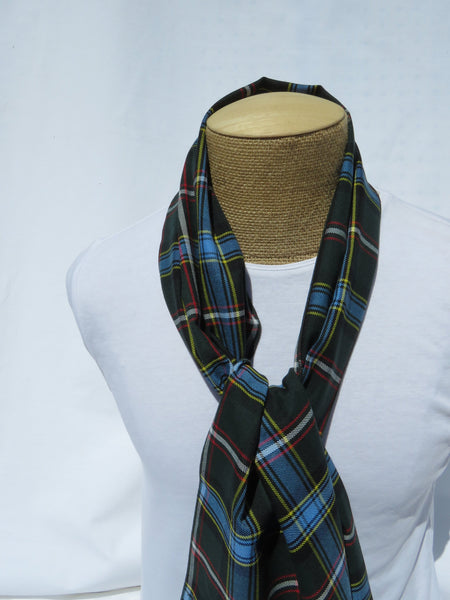 Green and blue plaid scarf knotted arouond a manequin torso