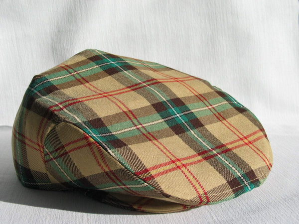 A gold plaid, Saskatchewan tartan flat cap on a white background.